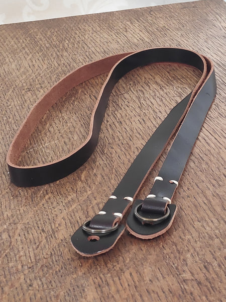 One Black, brown or dark brown leather camera strap for vintage cameras.